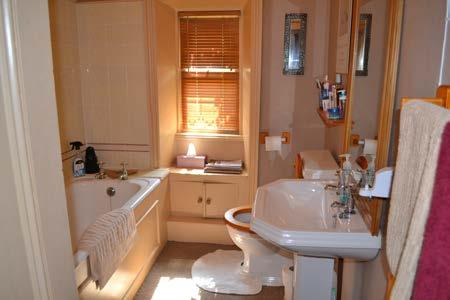 Bathroom: Three piece suite with panel bath, electric shower over, pedestal wash basin, low level WC, leaded