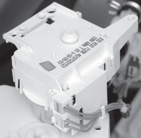 d) Remove the motor and switch wires from the wire clip. e) Disconnect the two wire connectors from the motor terminals.