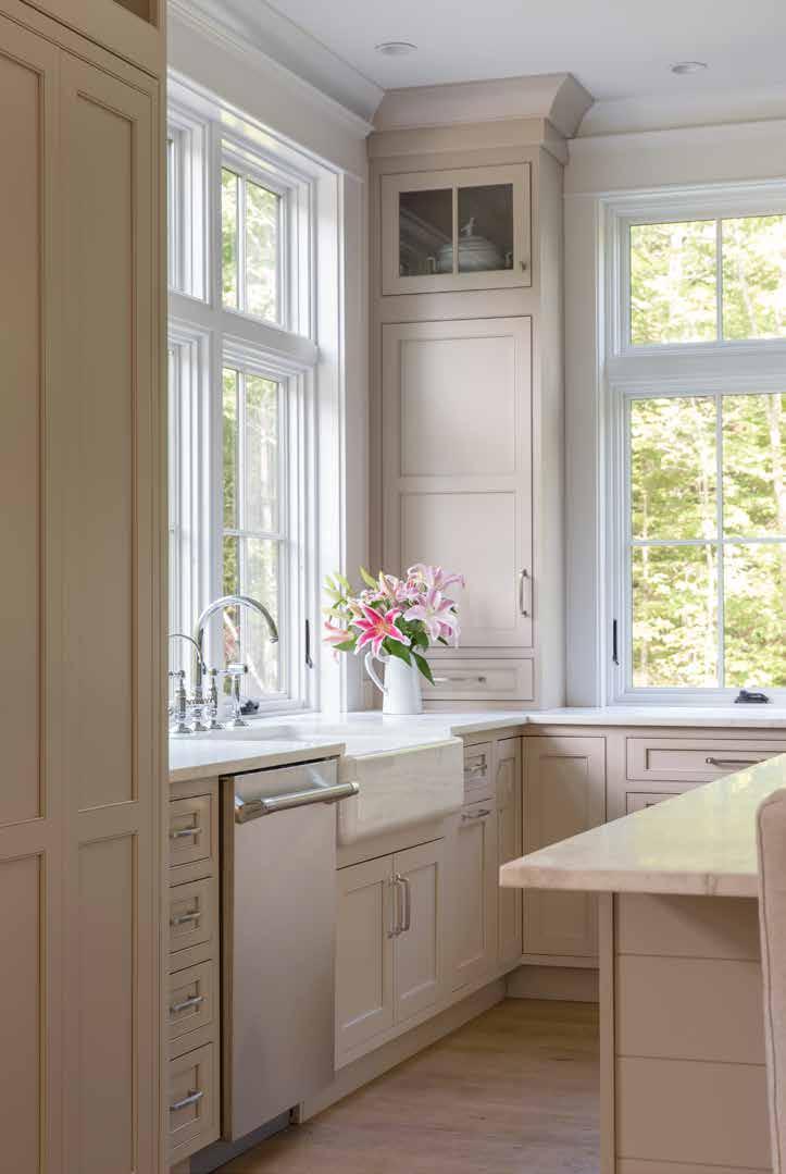The team at Kitchen Cove Cabinetry and Design worked with the architects to limit upper cabinetry to maximize natural light.