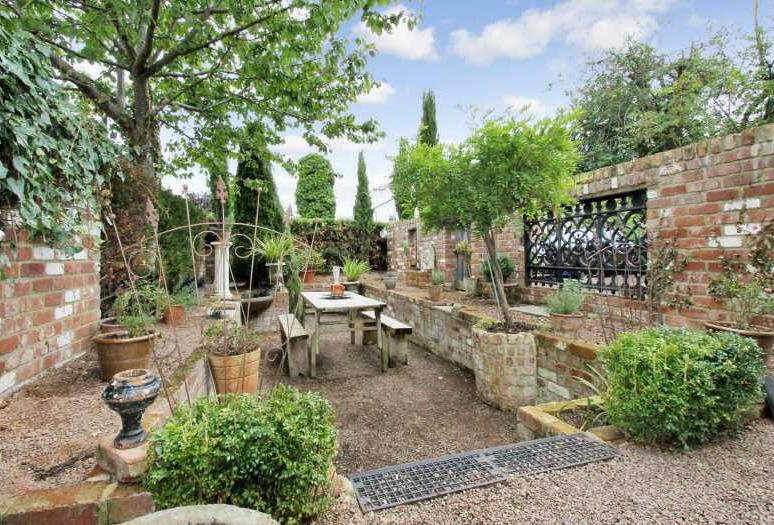 At the rear of the property there is an extensive patio that extends the full length of the rear with a seating area at one end and a frontage of box hedging.