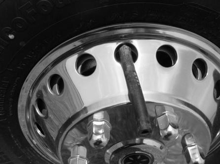 SECTION 3 DRIVING YOUR MOTORHOME VALVE STEM ACCESS (Mercedes-Benz Sprinter Chassis) Front Wheel Valve Stem Access on 18-Hole Steel Wheel with Push-On Full Wheel Trim If