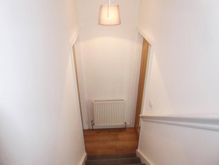 INNER HALL 3' 4" x 2' 9" (1.02m x 0.84m) Central heating radiator. Light neutral decor. Moulded skirting boards and door architraves. Kardean 'summer oak' style flooring.