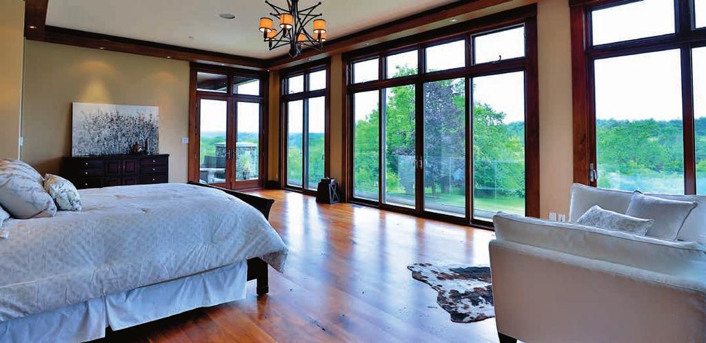 floor to ceiling glass doors with multiple walk-outs to back deck MASTER DRESSING ROOM Walnut floor Custom