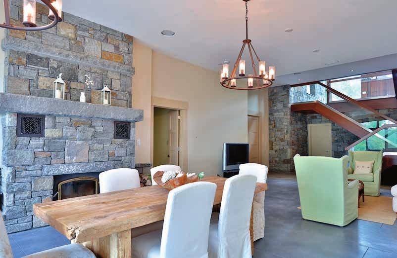 GROUND LEVEL (RECREATION ROOM + EAST WING) ACCESS TO GARAGE RECREATION ROOM Heated polished concrete floor Floor to ceiling wood burning fireplace with Adirondack granite and solid granite lintils