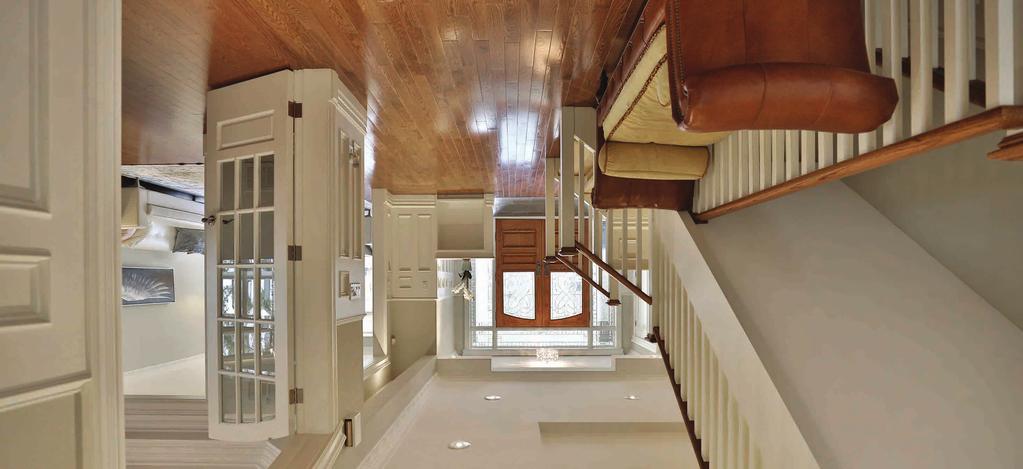 This spacious foyer with it s wainscoting,