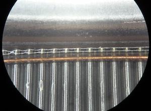 Figure 5: Stainless tubes and manifolds Figure 6: Cured epoxy view under a microscope The preferred epoxy adhesive was a single-component Loctite 3981 which cures at 1 C