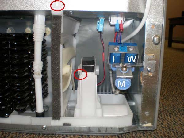 Condenser Fan and Motor Remove the screw at the top of the fan housing. Remove two screws that attach the fan motor to the housing.