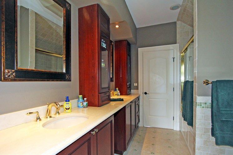 shower stall Study/library with hardwood floor, wood walls, wood coffered ceiling, recessed lights, built-ins and bay window Powder room with crown molding and vanity Mud room with radiant heat,