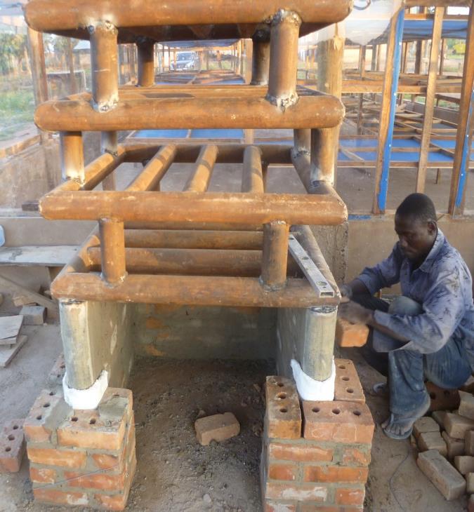 Forming heat exchanger Laying of HDRB Figure 8: Construction of biomass furnace at site Laying of ordinary bricks
