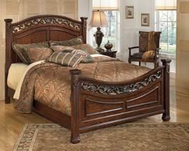 select birch veneers and hardwood solids Glazed cherry finish has dry brushed edges Dramatic panel bed features replicated pierced metalwork Fluted pilasters have leaf