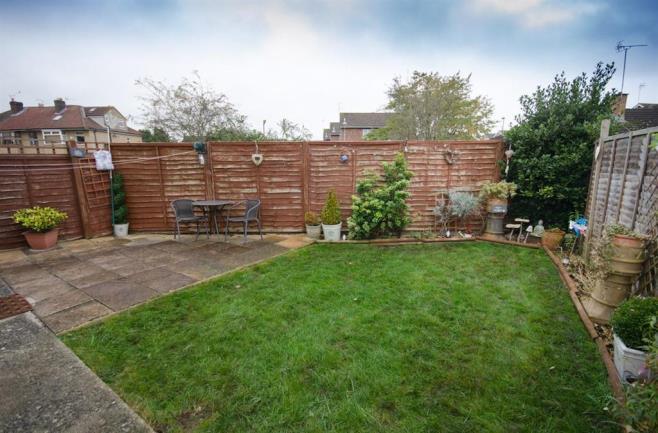 REAR GARDEN Laid to lawn and paved patio with herbaceous borders, electric point, water tap, outside lighting, garden surrounded by wooden fencing, wooden gate providing side pedestrian access.