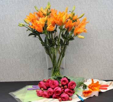 Your styling vase can be a plastic utility container that is large and tall enough to hold a typical bundle, bunch, or bouquet of flowers.