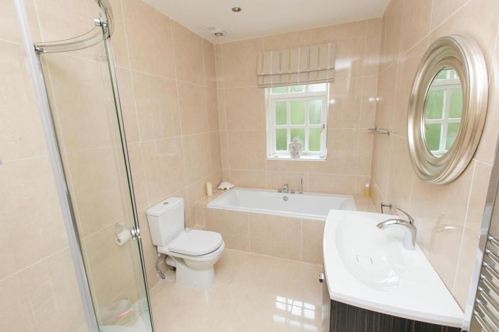 LUXURY BATHROOM White suite comprising panelled bath with telephone hand shower over; corner shower cubicle with