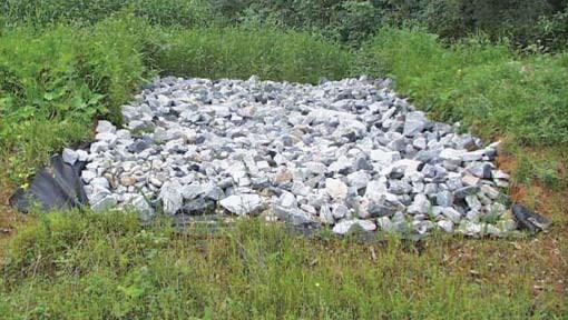 rock baffle slows the flow of water from one area of a stormwater pond to another