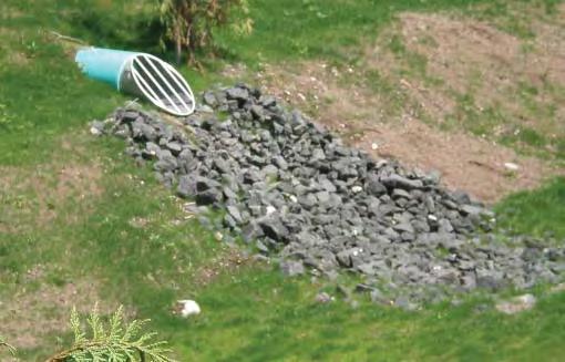 ACTION ITEMS: Replace scattered rocks and remove weeds and excessive sediment.