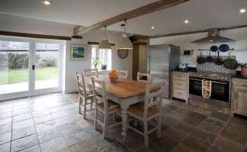Careful consideration has been taken to retain many of the barns original features including the wonderful natural stone, open beams, a working fireplace and hard floors.