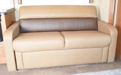 With the strap pulled down, lift the front edge of the sofa seat upward.
