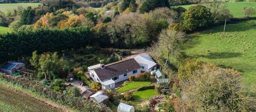 DESCRIPTION Situated at the end of a no-through country lane, this beautifully presented detached bungalow offers modern living in a rural setting amongst the rolling Devon countryside.