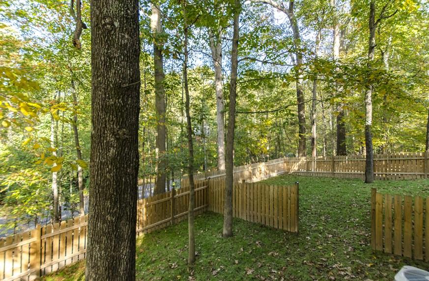 The back deck is accessible from the living room and creates an outdoor living space that is perfect for dining/ entertaining and enjoying the serene natural setting.