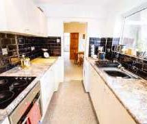machine; built-in electric cooker and hob; a range of matching wall units and shelving;