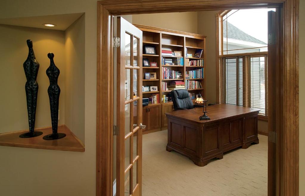 Glass-paned French doors give entrance to the soaring windows and lofty bookcases of the stunning home office. Outside the doors, an eye-catching decorative niche was created. they get fixed?