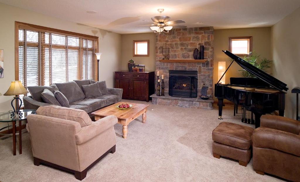 The classic design of this family room, adjacent to the kitchen, allows it to serve many purposes music room, a place to converse with friends or an entertainment area with a big-screen TV concealed
