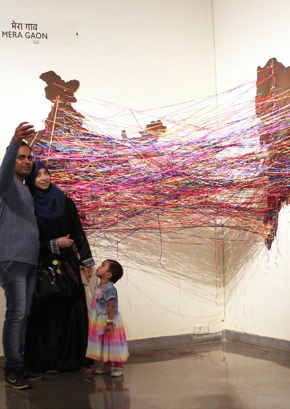 04 MERA GAON This interactive installation comprises a map of Mumbai, a map of India, colourful threads and pins.
