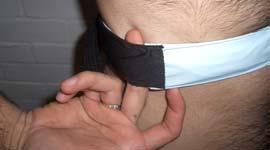 Tighten strap by holding the buckle with the left hand and pulling the