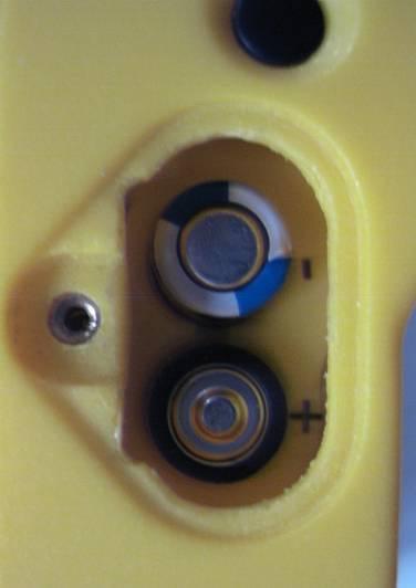 The batteries are accessed through the panel on the side of the instrument.