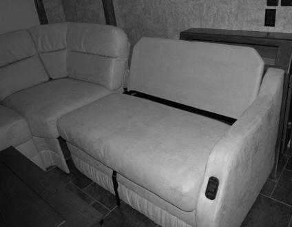 Grasp the black pull strap (located on the front side of the sectional extension seat cushion) and pull UP and OUT.