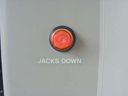 The light will come on briefly and a chime will sound when the ignition key is turned to the On or Run positions if the jacks are down.