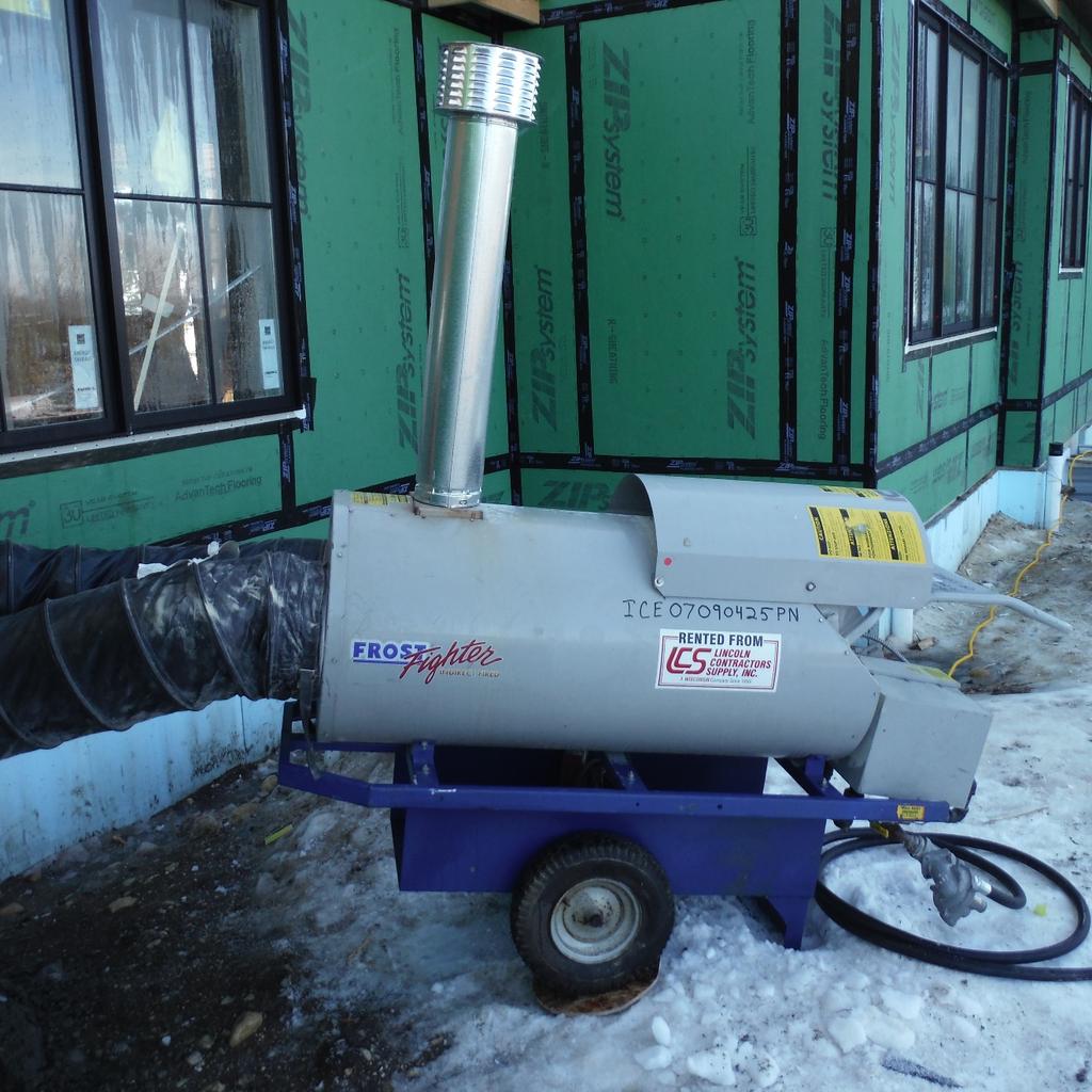 Another type of temporary heater has its combustion chamber and a heat exchanger located on a trailer outside the building (Photo 2).