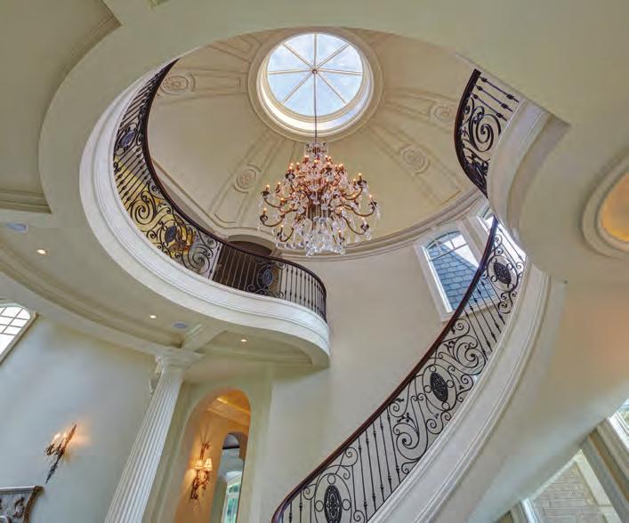 The powerful fluted columns support the cantilevered balcony, with its intricate a decorative wrought iron