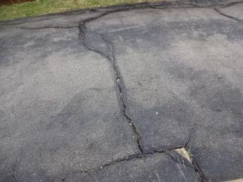 1. Driveway Condition Exterior Materials: Asphalt Common cracks observed on the driveway. Recommend filling the cracks and coating the driveway to extend its life.