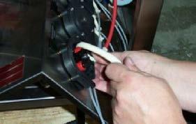 With the needle-nose pliers, remove the motor wire from the prime switch, being