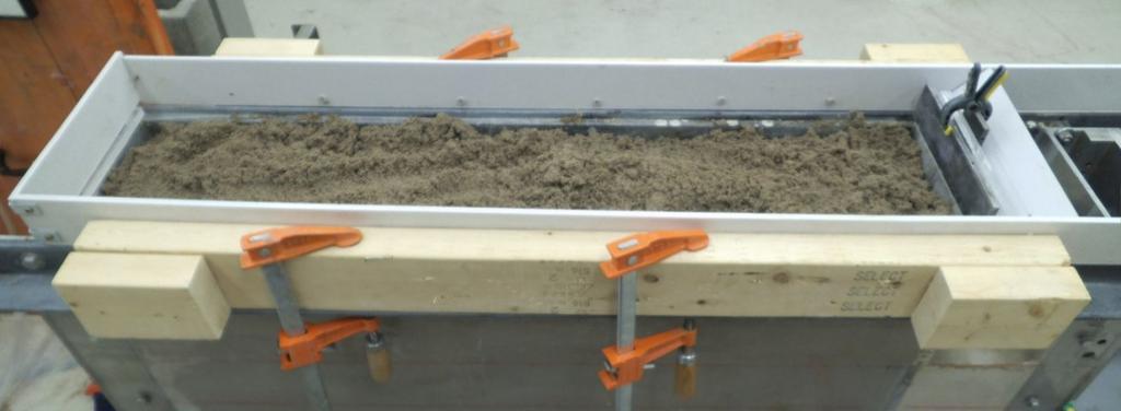 The compaction unit consists of a 4.5kg hammer that drops from a height of 45.7 cm on an aluminum compaction plate of 19.4mm by 35.5mm as seen in figure 3.7. The testing tank was divided into four equal layers.