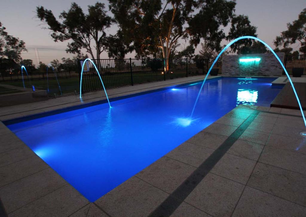 Dramatically lit water spouts with a matching sheer decent blade in the water feature are captivating in this night