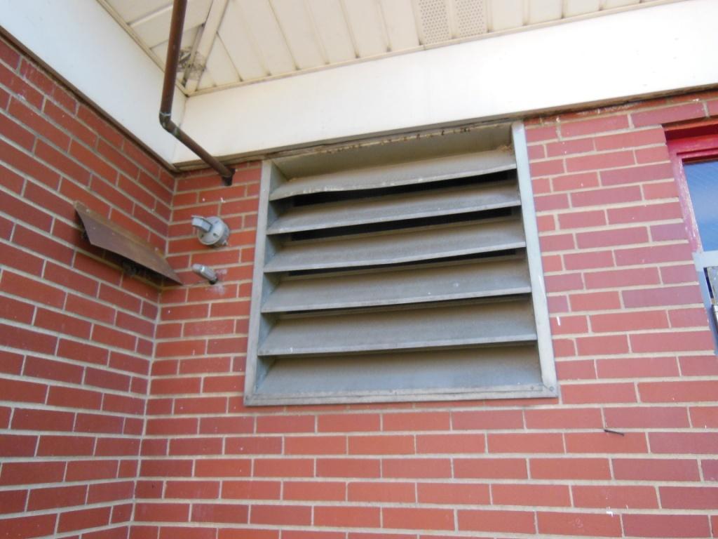Existing combustion air louver blanked off with sheet metal and placed by