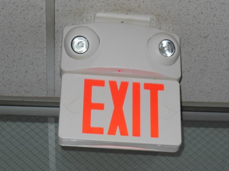 Installation of combination exit sign/emergency lighting with (2) 5-watt MR16 lamps.
