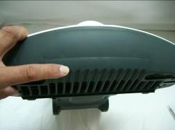 - 1) Relocate the protection grill by inserting the 3 pins in
