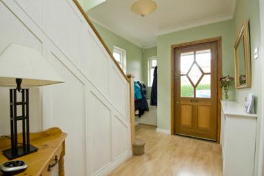 The Property Comprises: COVERED ENTRANCE PORCH: Outside light. Hardwood front door with glazed panels to.