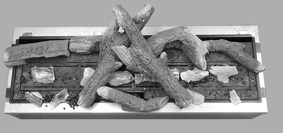 1. Place 2 large central logs as shown. 2. Place 2 largest charred pieces under 2 large logs keeping them in between front and back row of burner slots as shown. 3.