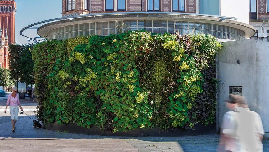 green living architecture Green Living Architecture is the integration of plants and water with built form. A vertical garden or living wall is a garden that is turned sideways.