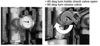 Remove the temperature gauges located in the two isolation valves. With a wrench on the flat spots of the valve, turn 45 degrees.