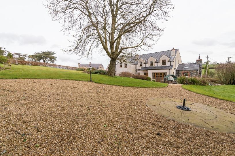 Set in its own delightful, landscaped gardens overlooking the countryside, this stunning family residence is the epitome of good taste, style and sheer quality.