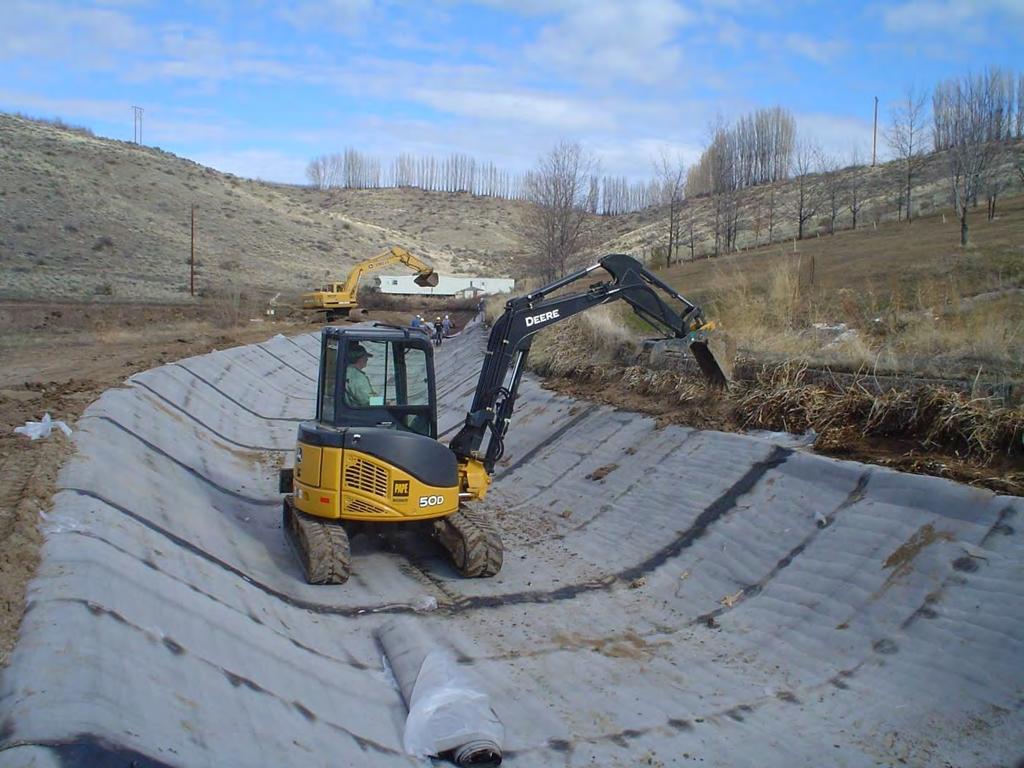 Figure 2: A rubber tracked excavator travelling on the bituminous geomembrane (BGM) for an irrigation canal, Washington State, USA.