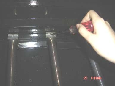 Remove the main tube burners by removing the screw securing the burners near the