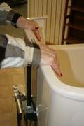 Pull the chair all the way into the tub, latching into the last rail notch.