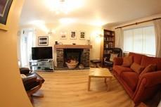 Living Room 1 settee 5 cushions 2 Leather reclining armchairs 2 Leather footstools 1 Wooden coffee