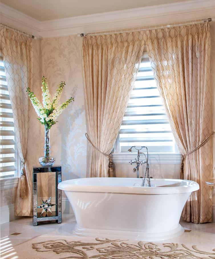Fabricut draperies by Custom Window Treatments Etc. frame the expansive windows in her master bath and give the room a graceful elegance along with a Romo wallcovering and a Surya rug.